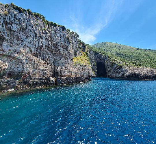 Speedboat inside Haxhi Ali Cave and turquoise waters of Karaburun Peninsula Vlorë